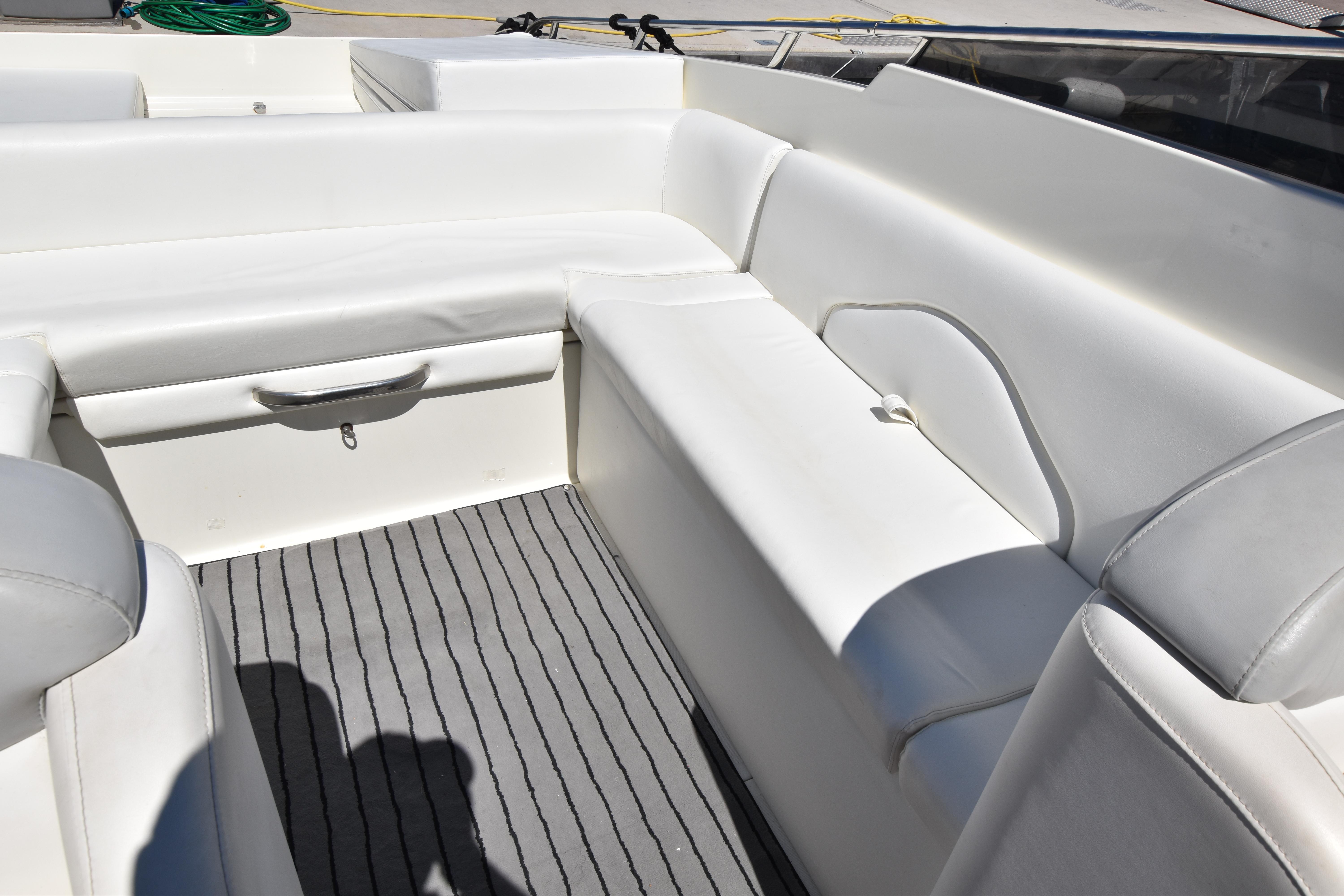 Luxurious white seating on a 2003 Performance 907 boat, featuring sleek design and comfort.