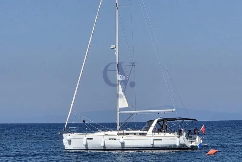 A Yacht Photos Pics 2018 Beneteau Oceanis 45 sailboat on calm sea with clear sky background.