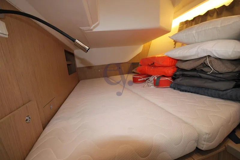 A Yacht Photos Pics Cozy cabin interior of 2018 Beneteau Oceanis 45 with bedding and life jackets.