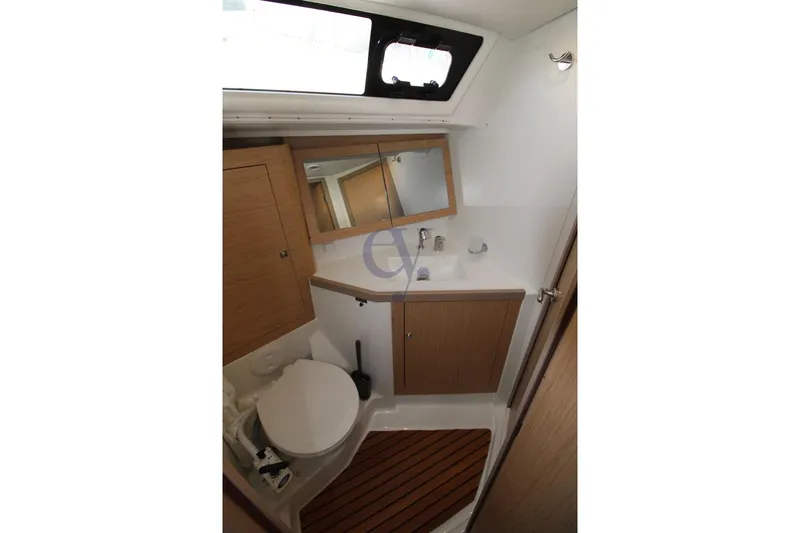 A Yacht Photos Pics Bathroom interior of 2018 Beneteau Oceanis 45 yacht, featuring wooden cabinetry and modern fixtures.