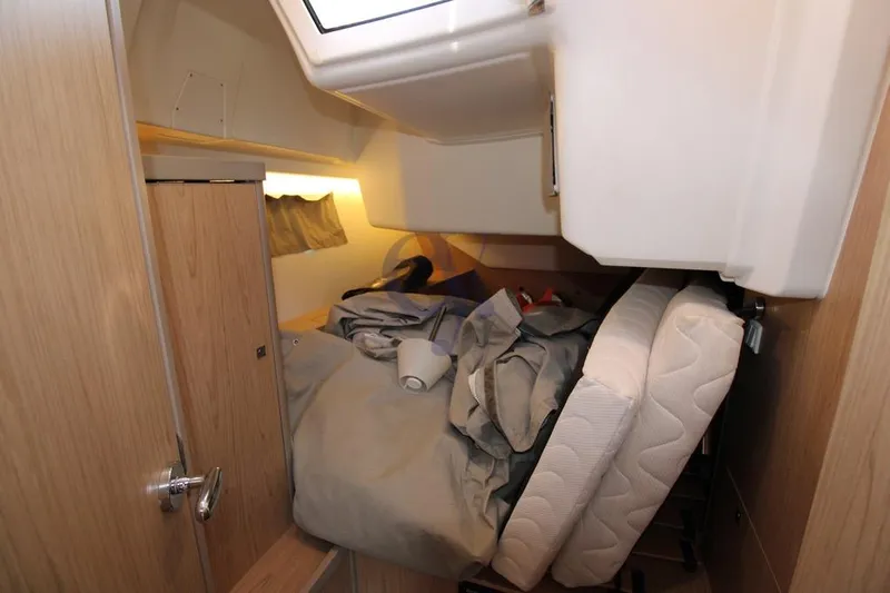 A Yacht Photos Pics Interior cabin of 2018 Beneteau Oceanis 45 yacht with disheveled bedding.