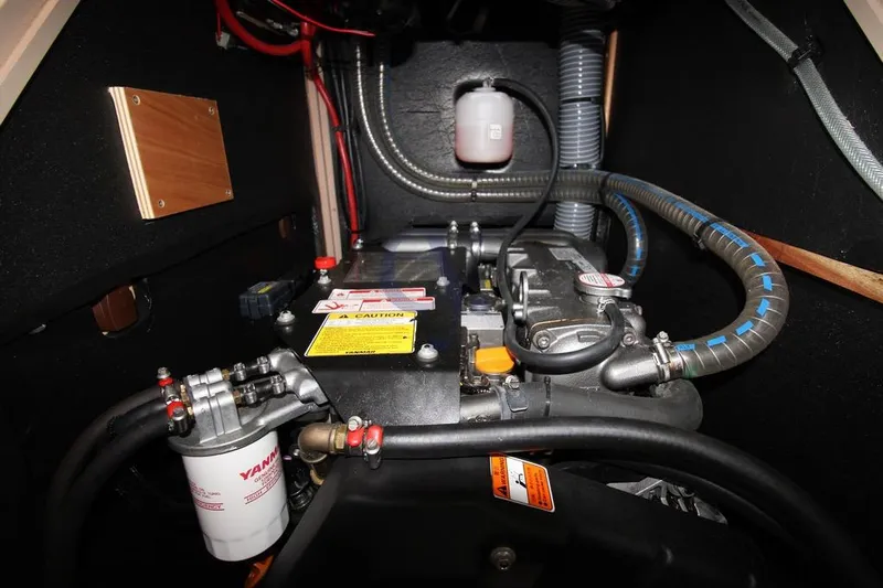A Yacht Photos Pics Engine compartment of 2018 Beneteau Oceanis 45 sailboat, featuring Yanmar components and hoses.