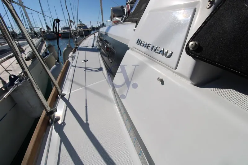 A Yacht Photos Pics 2018 Beneteau Oceanis 45 yacht deck, docked in a marina under clear skies.