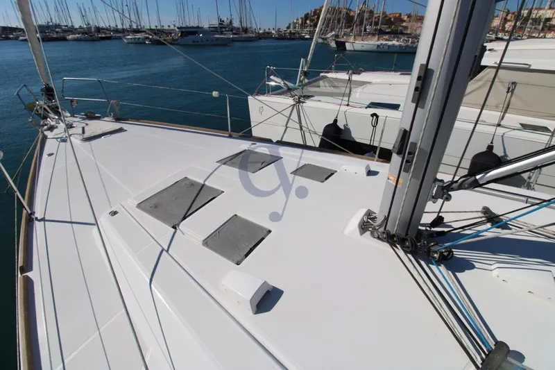 A Yacht Photos Pics 2018 Beneteau Oceanis 45 yacht deck in marina, showcasing sleek design and rigging.