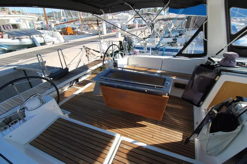 A Yacht Photos Pics 2018 Beneteau Oceanis 45 yacht cockpit with wooden deck and dual steering wheels.