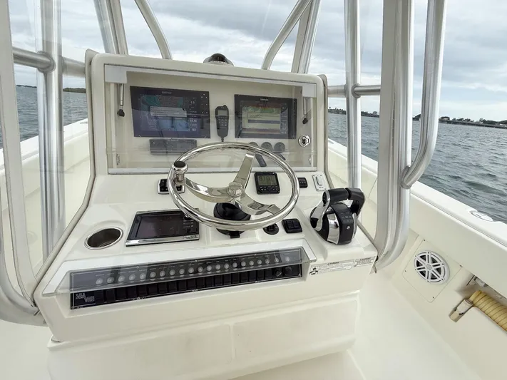  Yacht Photos Pics 2015 SeaVee 340Z boat console with steering wheel and navigation screens on open water.
