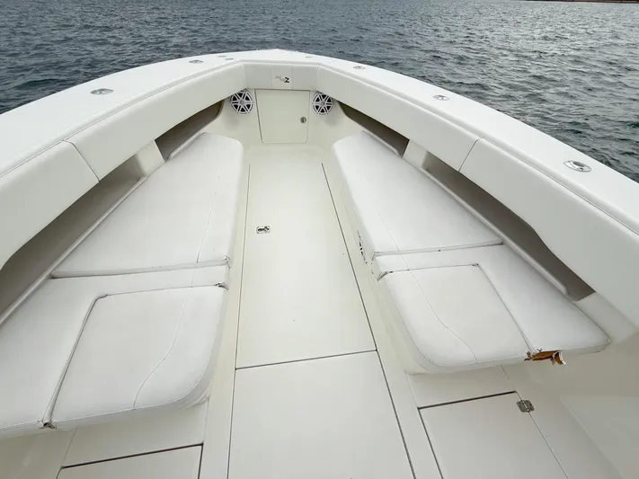  Yacht Photos Pics 2015 SeaVee 340Z boat interior with white cushioned seating on calm water.
