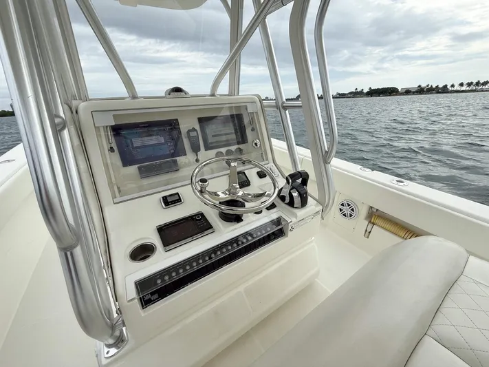  Yacht Photos Pics 2015 SeaVee 340Z boat console with steering wheel and navigation screens on open water.