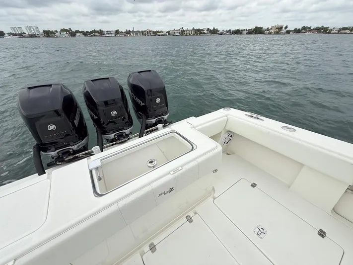  Yacht Photos Pics 2015 SeaVee 340Z boat with triple outboard engines on calm water.