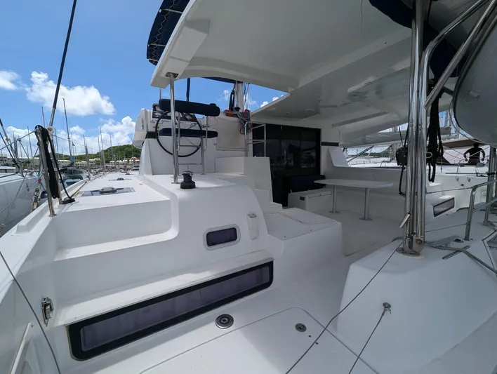 Mango IV Yacht Photos Pics 2017 Lagoon 42 catamaran deck with seating, docked at marina under clear blue sky.