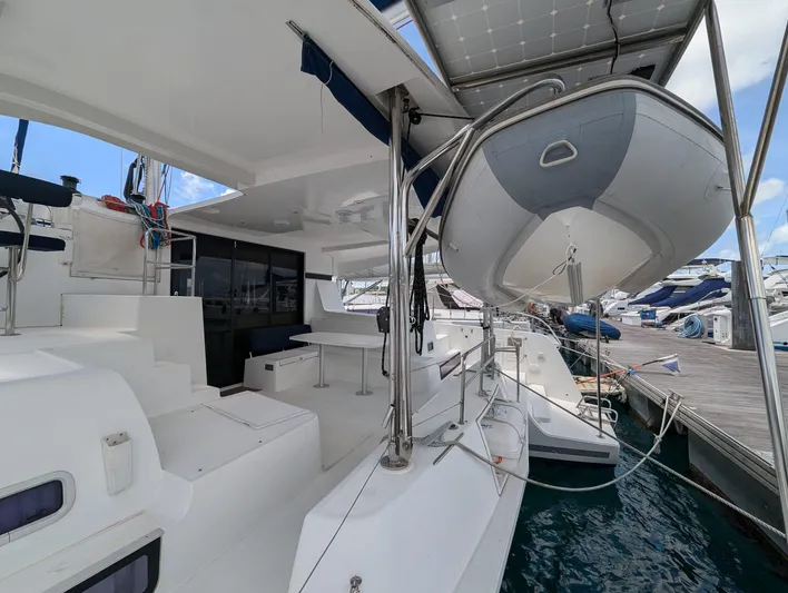 Mango IV Yacht Photos Pics 2017 Lagoon 42 catamaran docked, featuring spacious deck and dinghy.