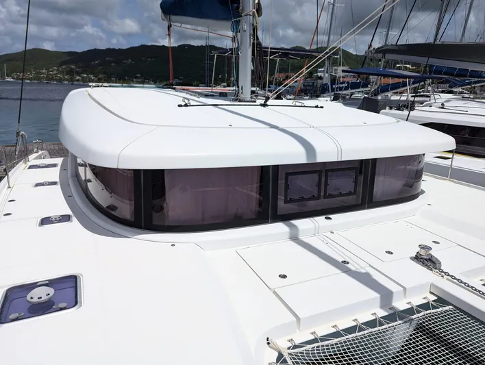 Mango IV Yacht Photos Pics 2017 Lagoon 42 catamaran with sleek design, docked at a marina under cloudy skies.