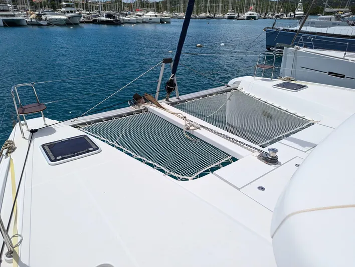 Mango IV Yacht Photos Pics 2017 Lagoon 42 catamaran docked in a marina, featuring netted deck area.