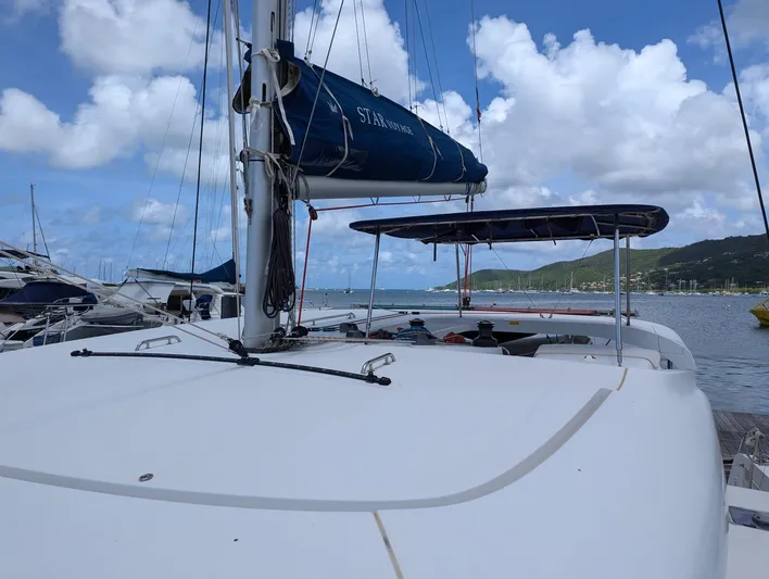 Mango IV Yacht Photos Pics 2017 Lagoon 42 catamaran docked at a marina under a blue sky.