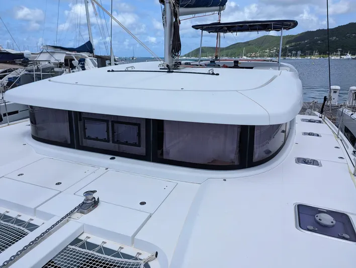 Mango IV Yacht Photos Pics 2017 Lagoon 42 catamaran docked, showcasing sleek design and spacious deck under a clear sky.