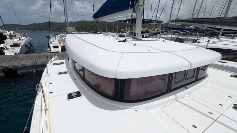 Mango IV Yacht Photos Pics 2017 Lagoon 42 catamaran docked at marina, showcasing sleek design and spacious deck.