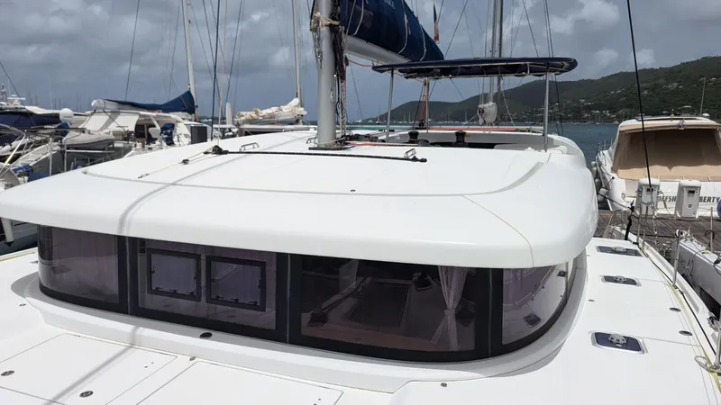 Mango IV Yacht Photos Pics 2017 Lagoon 42 catamaran docked at marina, featuring sleek design and spacious deck.