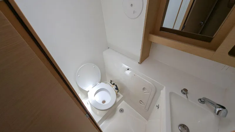 Mango IV Yacht Photos Pics Bathroom interior of a 2017 Lagoon 42 yacht, featuring a toilet and sink.