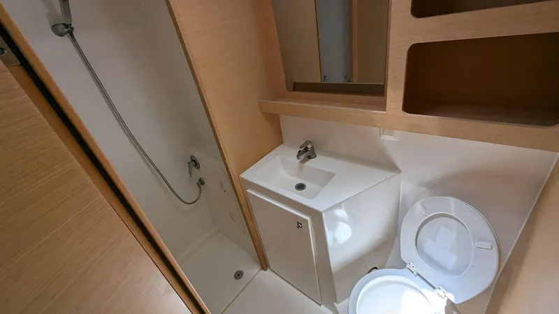 Mango IV Yacht Photos Pics 2017 Lagoon 42 yacht bathroom with shower, sink, and toilet.