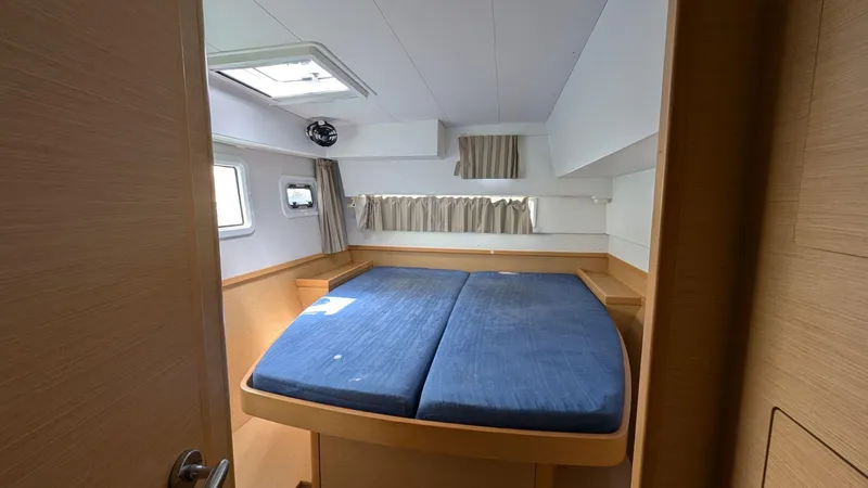 Mango IV Yacht Photos Pics Interior cabin of 2017 Lagoon 42 catamaran with blue bedding and natural light.