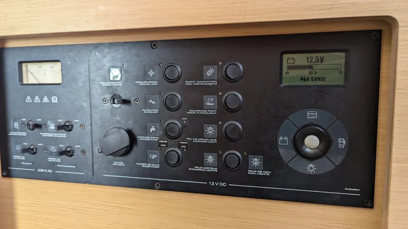 Mango IV Yacht Photos Pics Control panel of a 2017 Lagoon 42 yacht, displaying various switches and a digital screen.