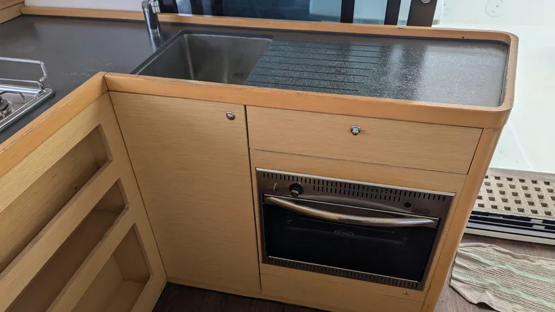 Mango IV Yacht Photos Pics Interior kitchen of a 2017 Lagoon 42 catamaran with sink and oven.