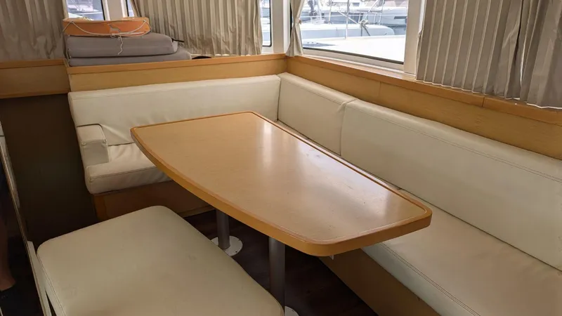 Mango IV Yacht Photos Pics Interior of 2017 Lagoon 42 yacht with beige seating and wooden table.