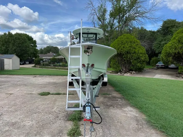  Yacht Photos Pics 2022 Sea Hunt Gamefish 27 boat on trailer, parked in a driveway.