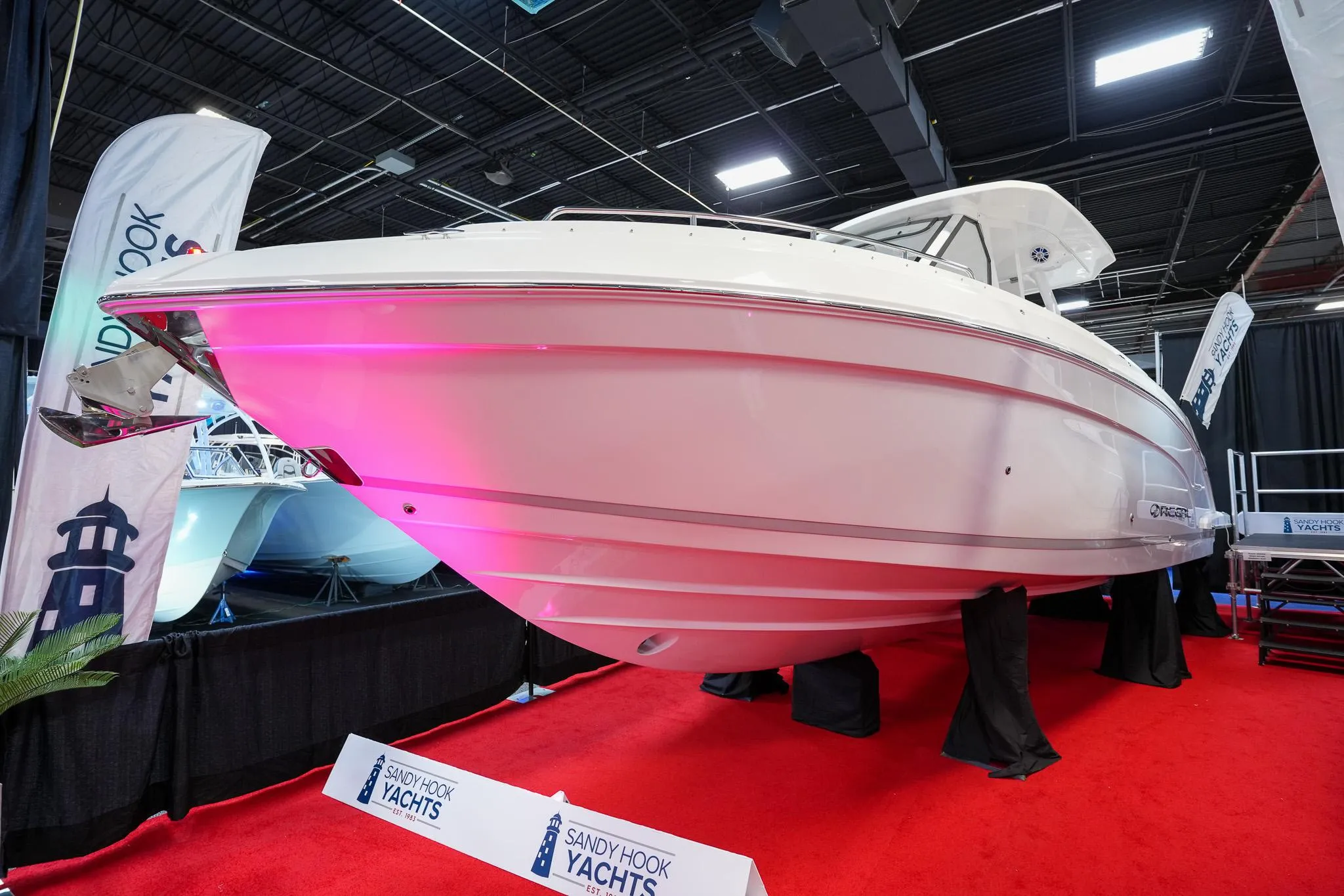 2025 Regal 33 SAV yacht displayed on red carpet at boat show.