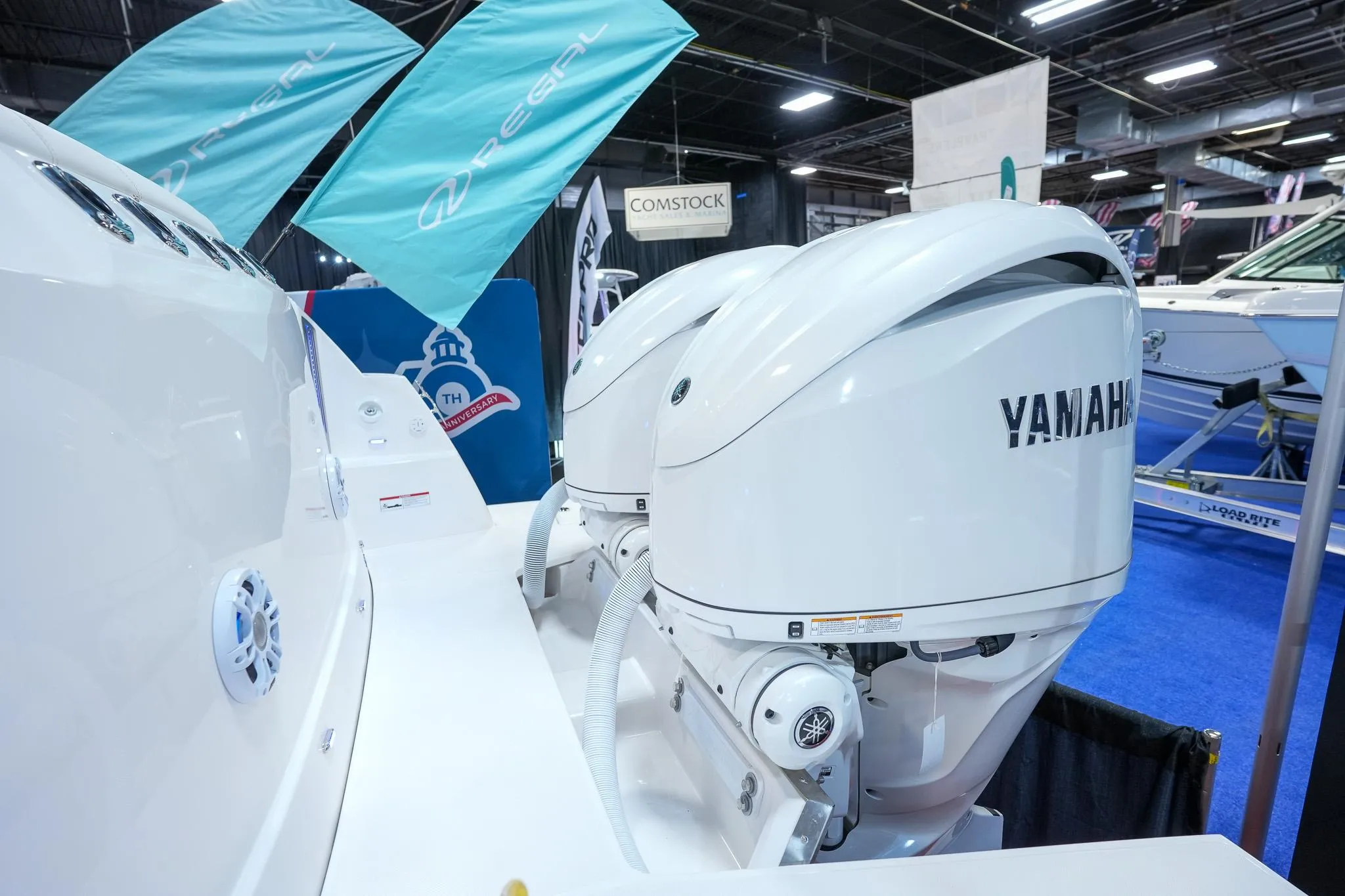 2025 Regal 33 SAV boat with Yamaha outboard engines at a boat show.