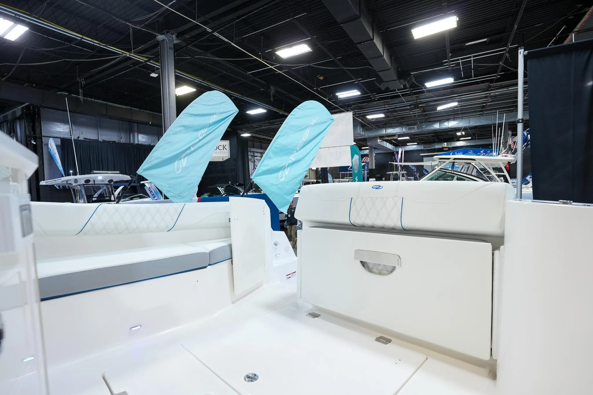 2025 Regal 33 SAV boat interior at an indoor exhibition, showcasing seating and design.