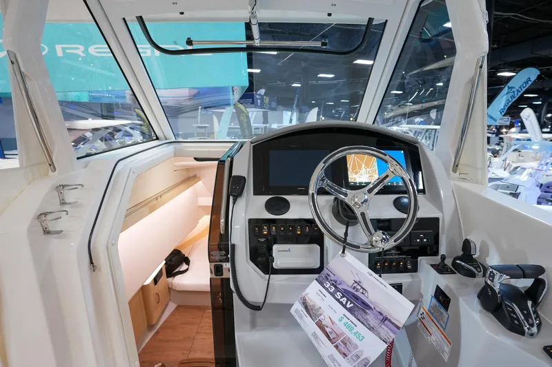  Yacht Photos Pics 2025 Regal 33 SAV boat interior with modern dashboard and steering wheel.