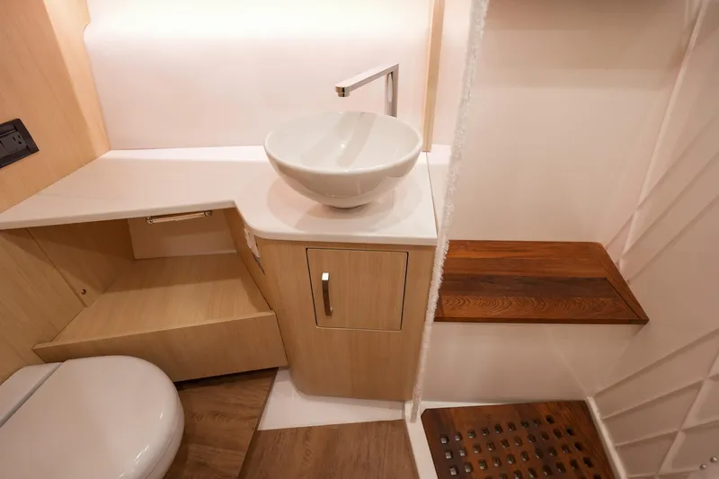  Yacht Photos Pics Modern bathroom interior of 2025 Regal 33 SAV boat, featuring sleek sink and wooden accents.