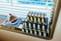 Decorative boxes and books on Custom Line Navetta 30 yacht, 2022, with ocean view.