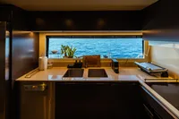 Luxurious kitchen on 2022 Custom Line Navetta 30 yacht with ocean view.