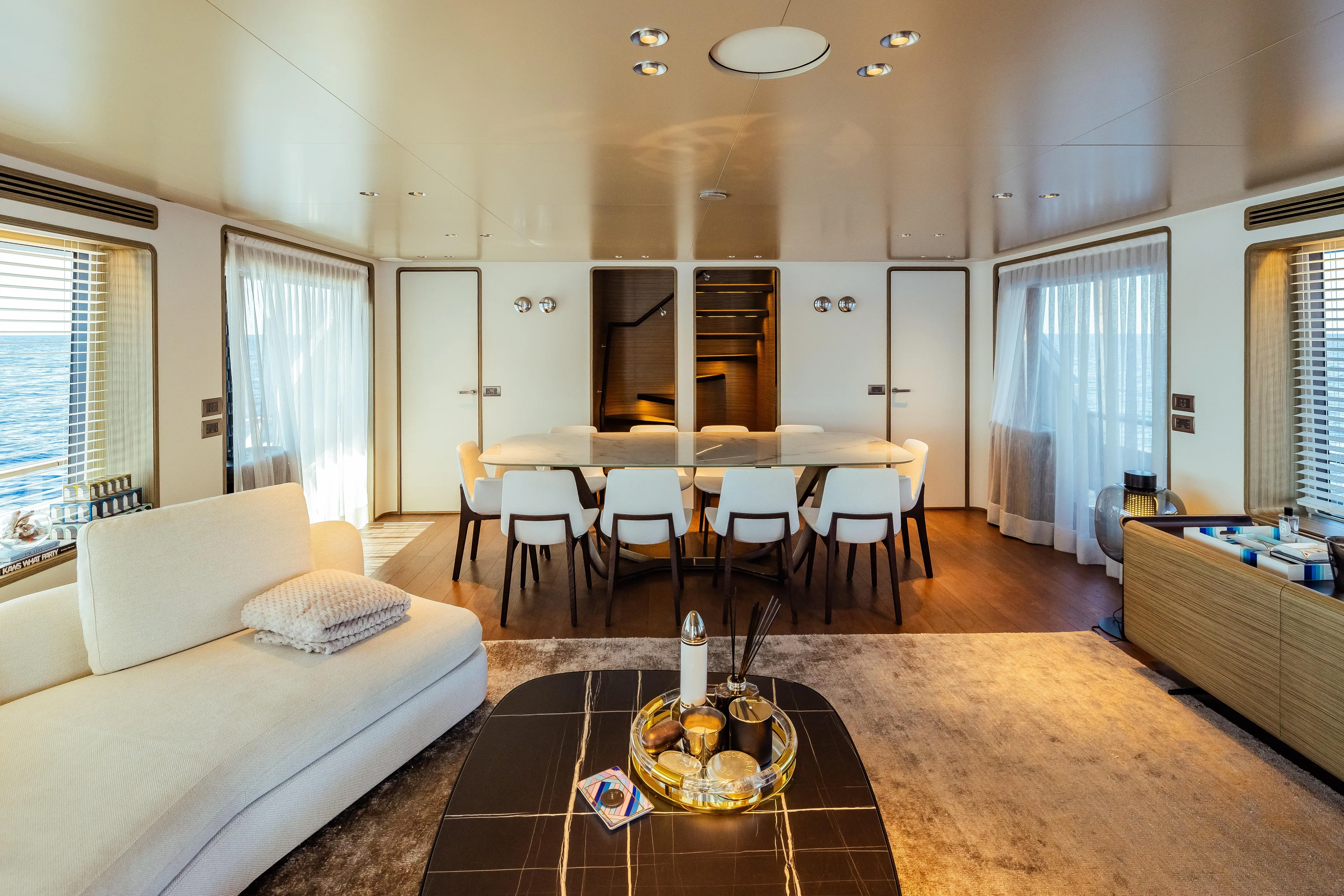 Luxurious interior of 2022 Custom Line Navetta 30 yacht, featuring elegant dining and living area.