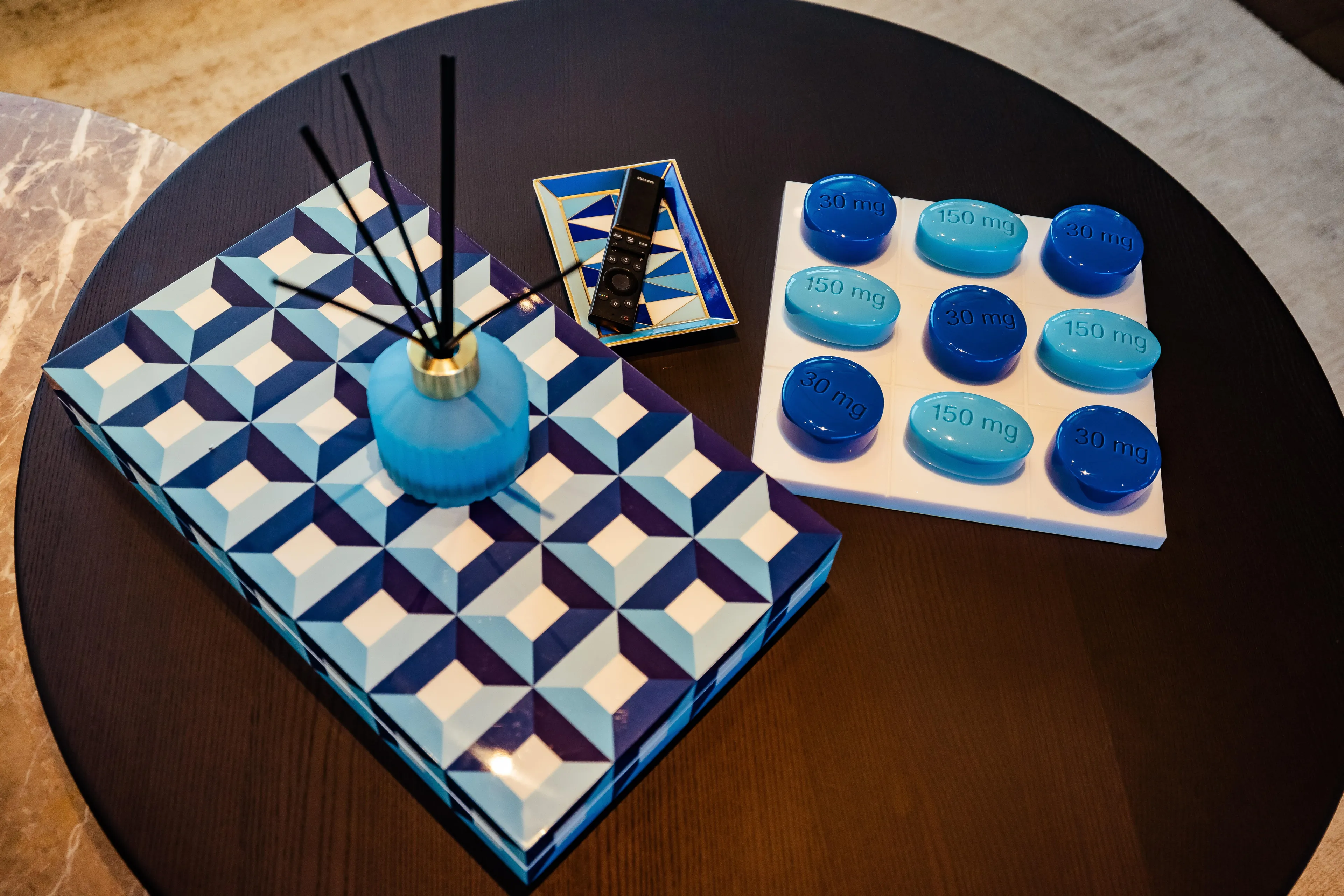 Luxurious table decor with geometric patterns and blue accents on Custom Line Navetta 30, 2022.