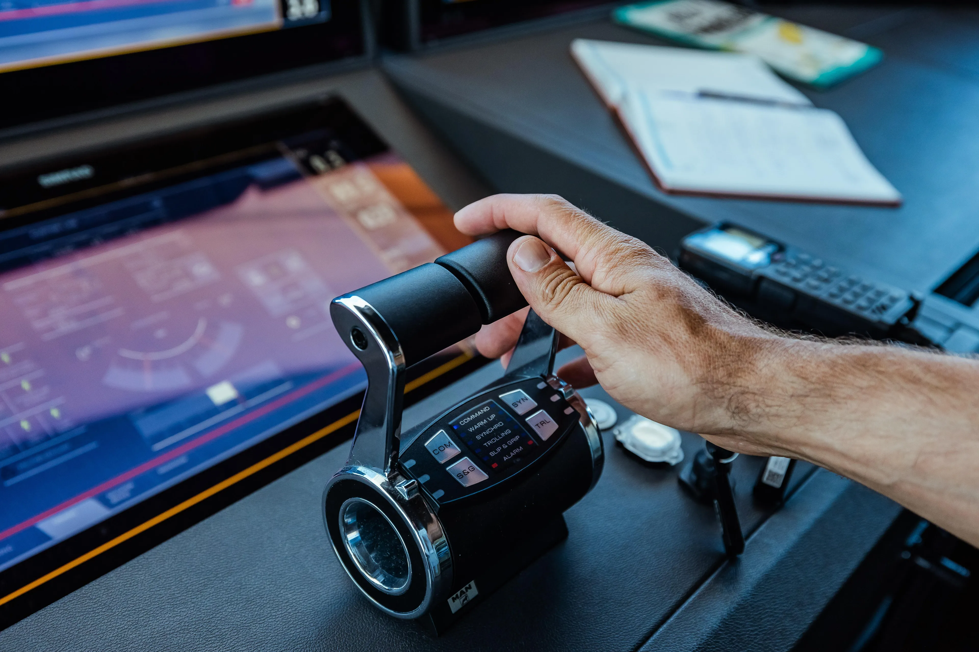 Hand operating controls on 2022 Custom Line Navetta 30 yacht dashboard.