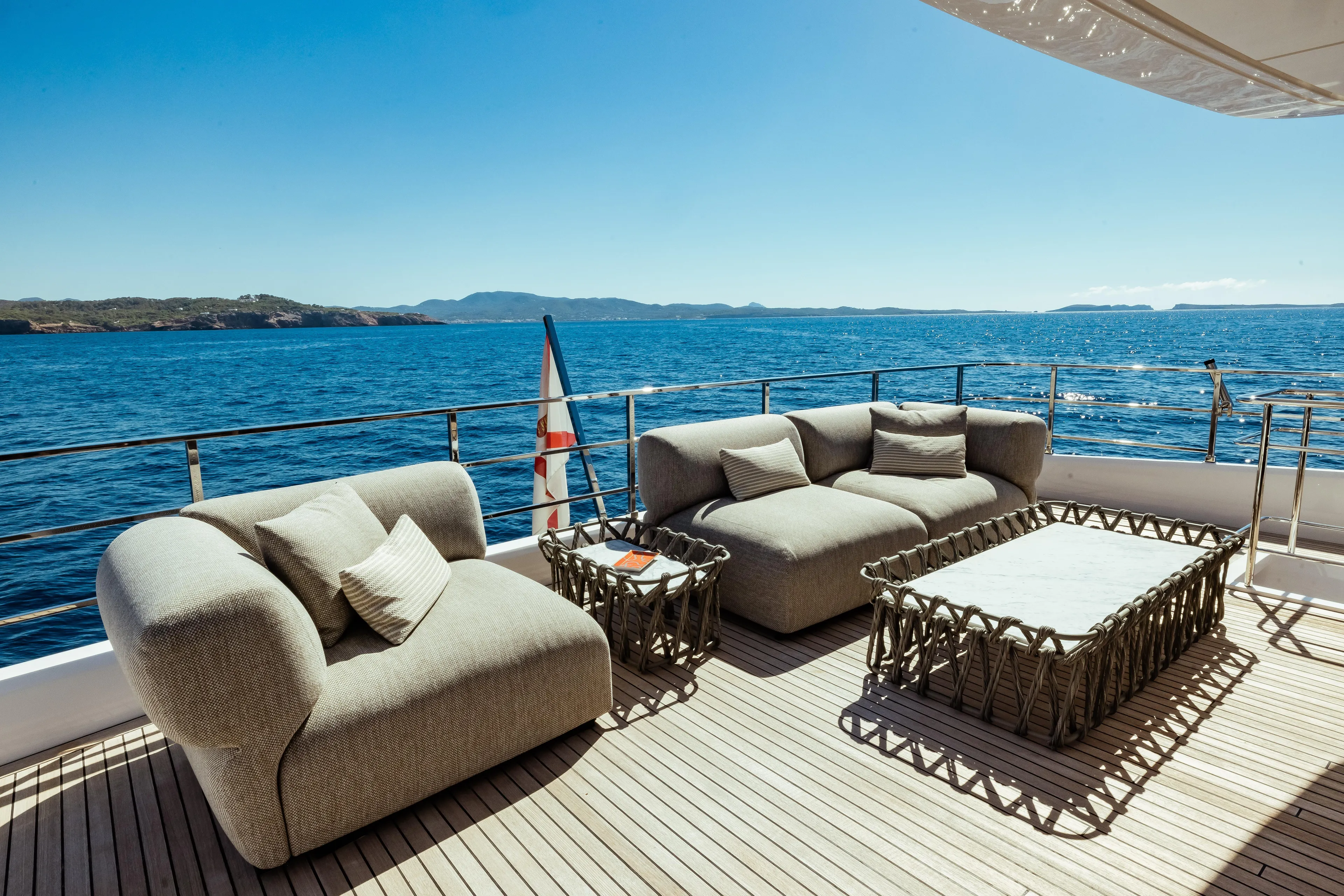  Yacht Photos Pics Luxurious outdoor seating on 2022 Custom Line Navetta 30 yacht, overlooking serene ocean views.