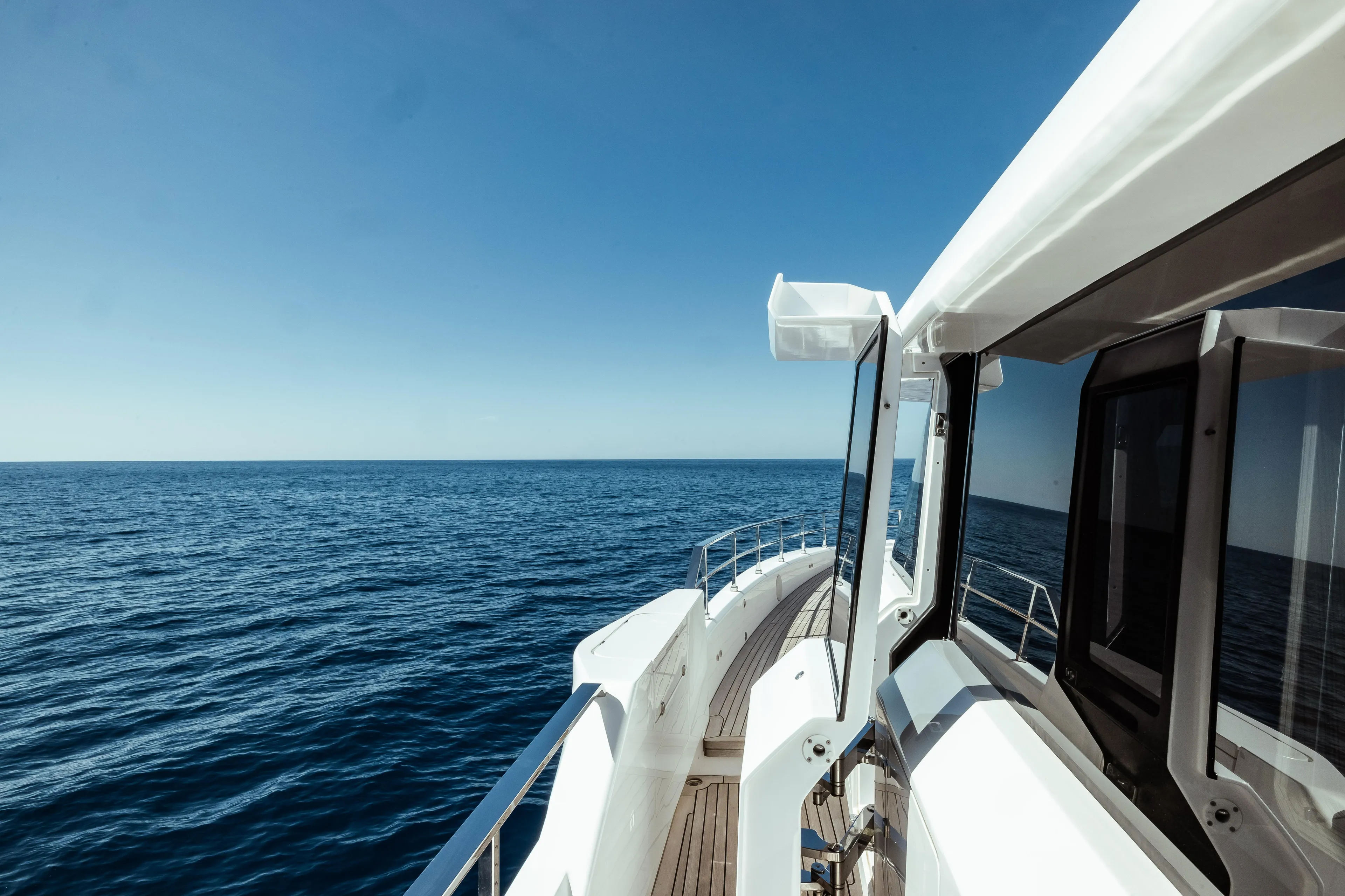  Yacht Photos Pics Custom Line Navetta 30 yacht cruising on open sea, 2022 model, clear blue sky.