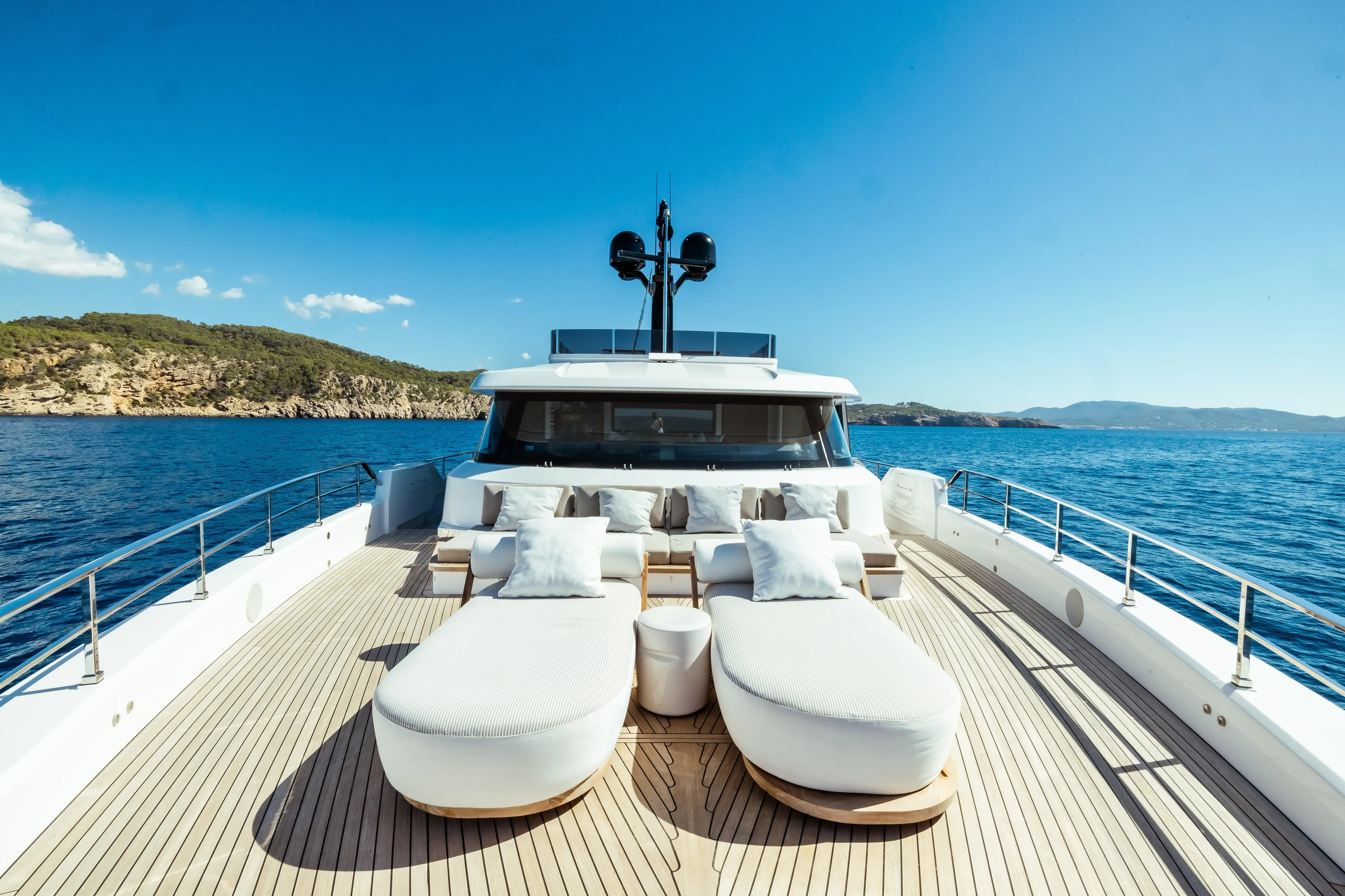 Luxurious 2022 Custom Line Navetta 30 yacht deck with sun loungers, ocean view.