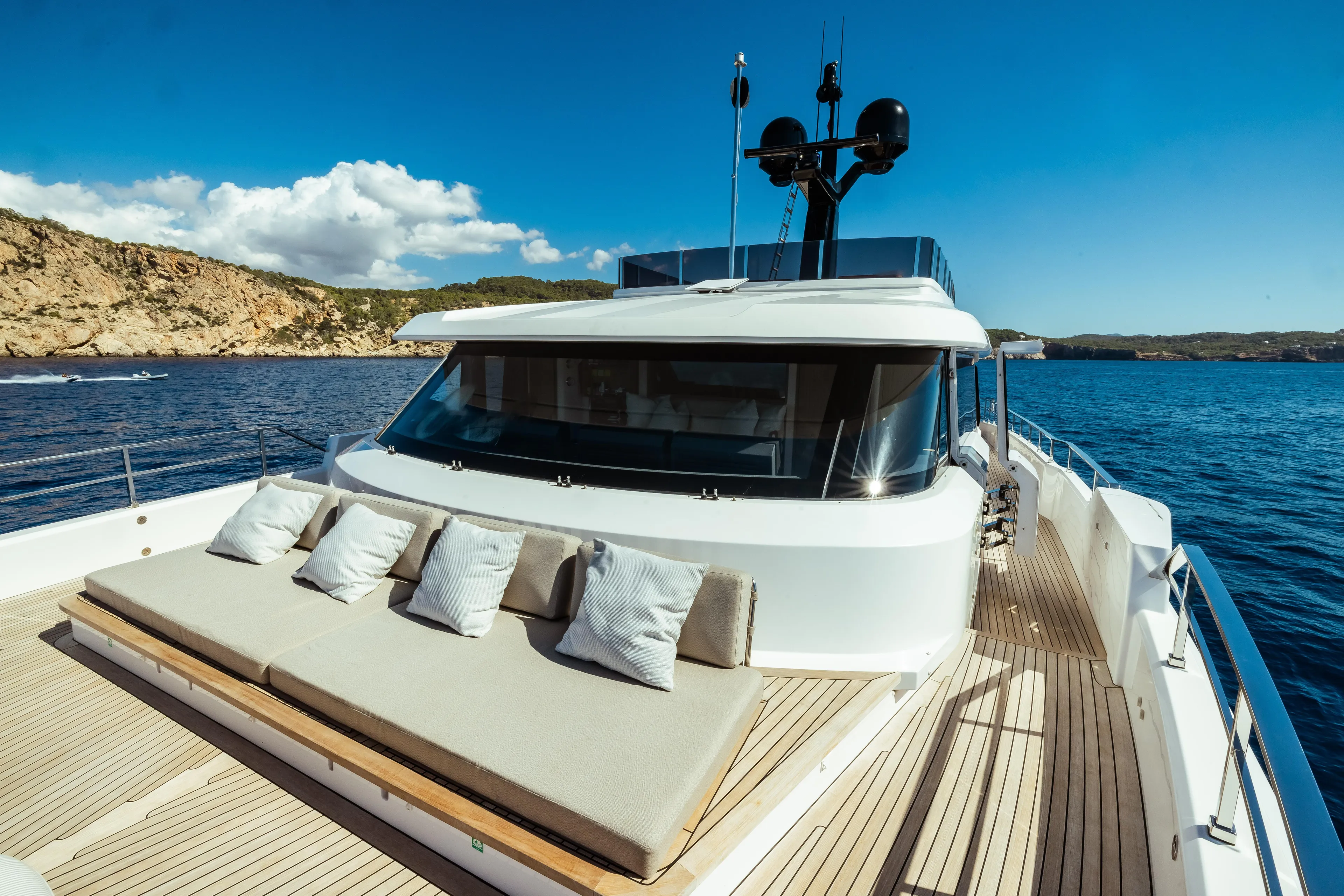  Yacht Photos Pics Luxurious 2022 Custom Line Navetta 30 yacht with sun deck, cruising on clear blue waters.
