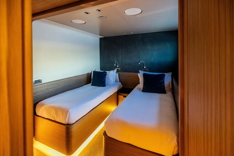  Yacht Photos Pics Luxurious twin cabin on 2022 Custom Line Navetta 30 yacht, featuring modern design and ambient lighting.