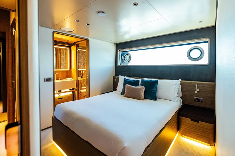  Yacht Photos Pics Luxurious bedroom on 2022 Custom Line Navetta 30 yacht with modern decor and ensuite bathroom.