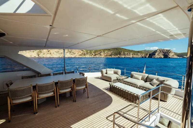  Yacht Photos Pics Luxurious 2022 Custom Line Navetta 30 yacht deck with elegant seating and ocean view.