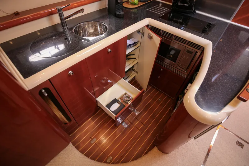  Yacht Photos Pics Luxurious 2008 Fairline Targa 52 GT yacht kitchen with sleek wood cabinetry and modern appliances.