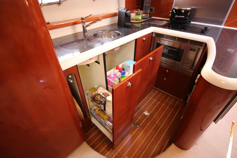  Yacht Photos Pics Luxurious 2008 Fairline Targa 52 GT yacht kitchen with sleek wood cabinetry and modern appliances.