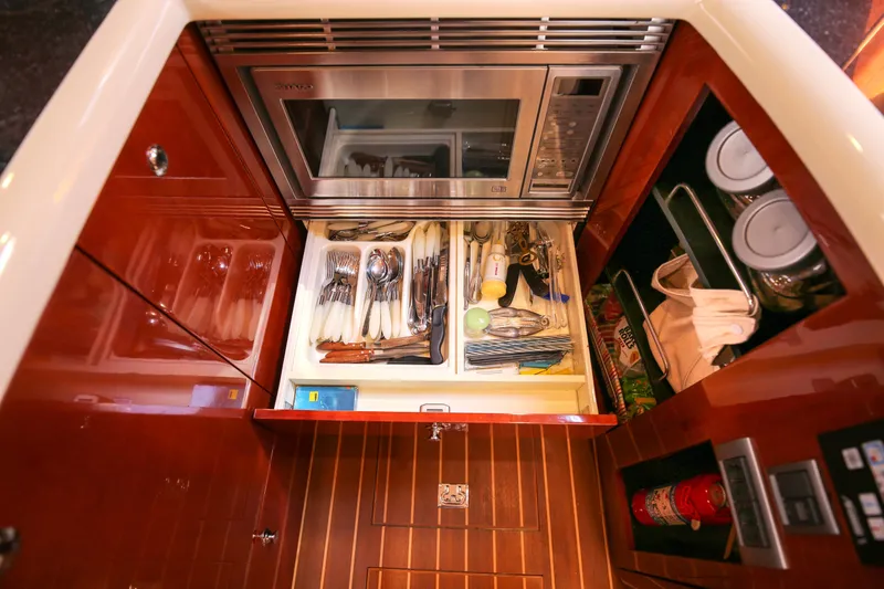  Yacht Photos Pics Luxurious 2008 Fairline Targa 52 GT yacht kitchen with microwave and organized cutlery drawer.