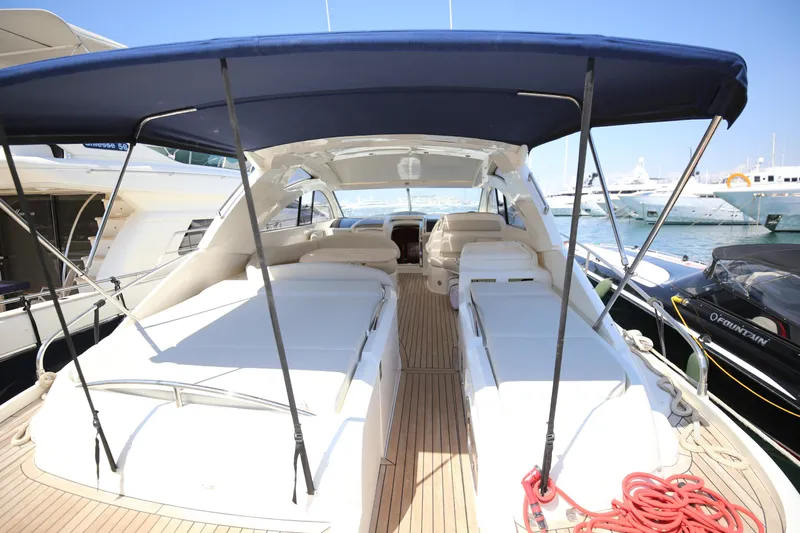  Yacht Photos Pics 2008 Fairline Targa 52 GT yacht with spacious deck and canopy in marina.