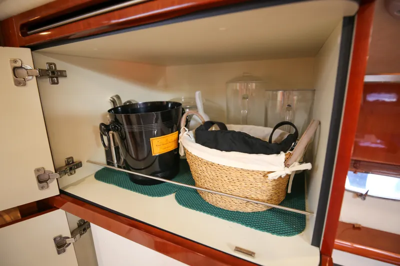  Yacht Photos Pics Cabinet storage on 2008 Fairline Targa 52 GT yacht with basket and ice bucket.